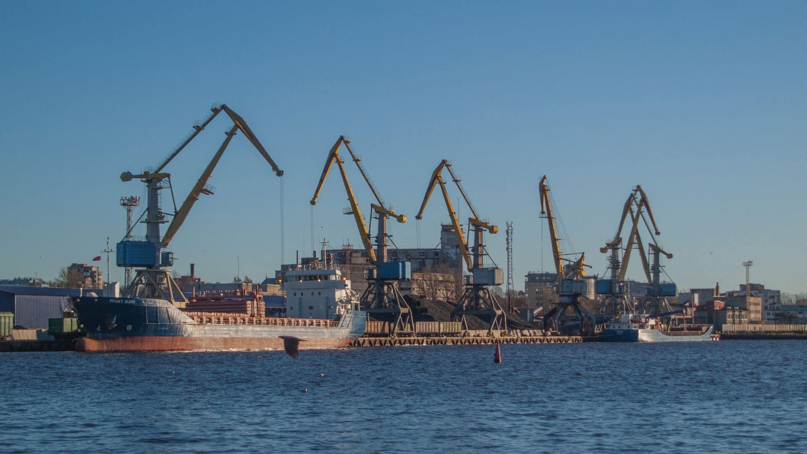 A busy shipping port in China with containers being loaded onto a ship