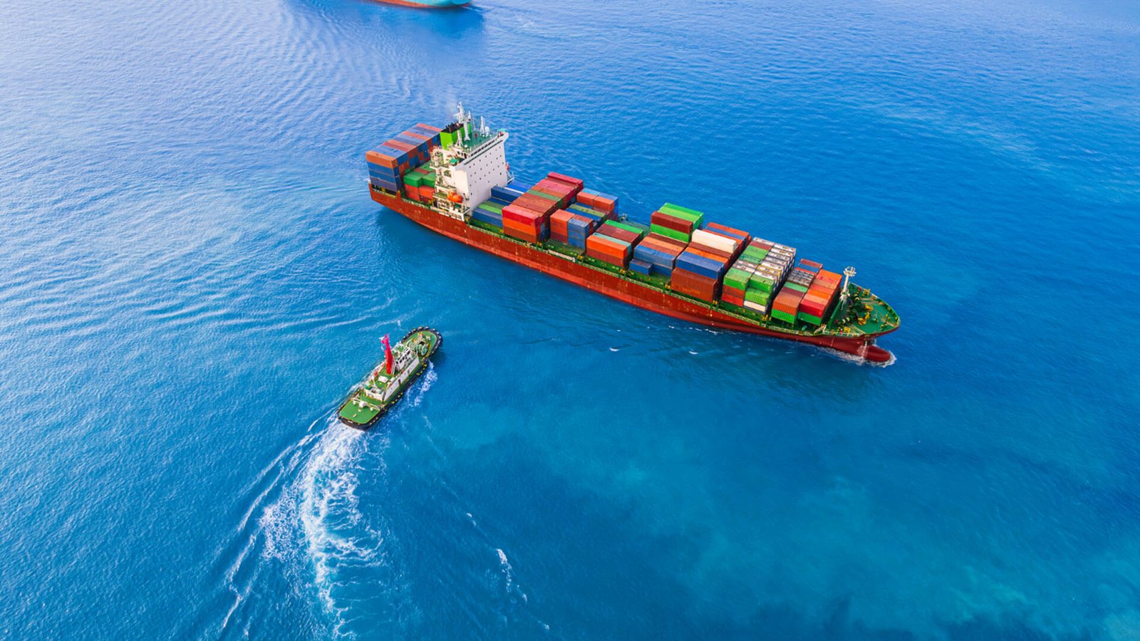 A busy shipping port with containers and cranes