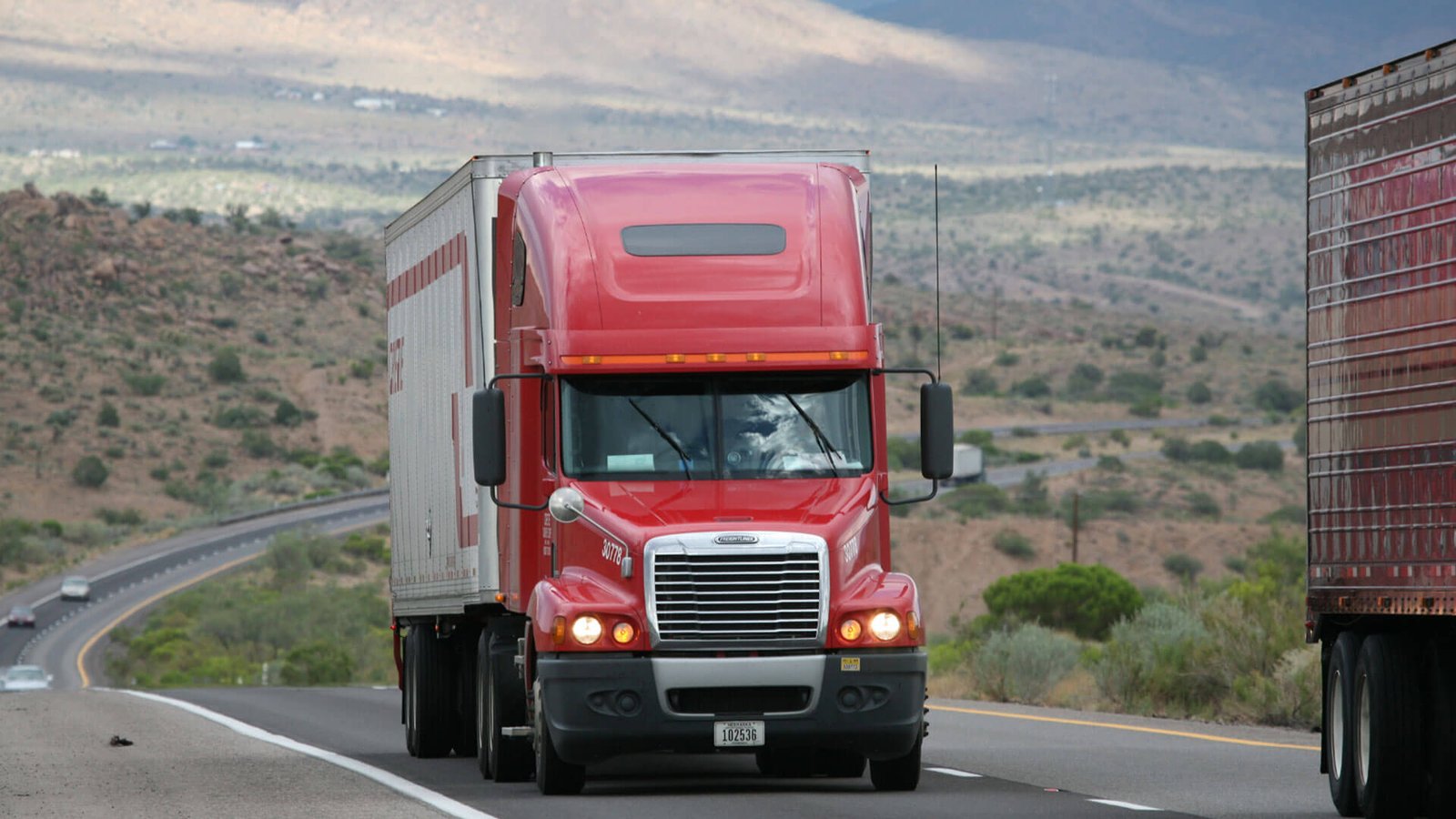 A person filling out an application form for an import license