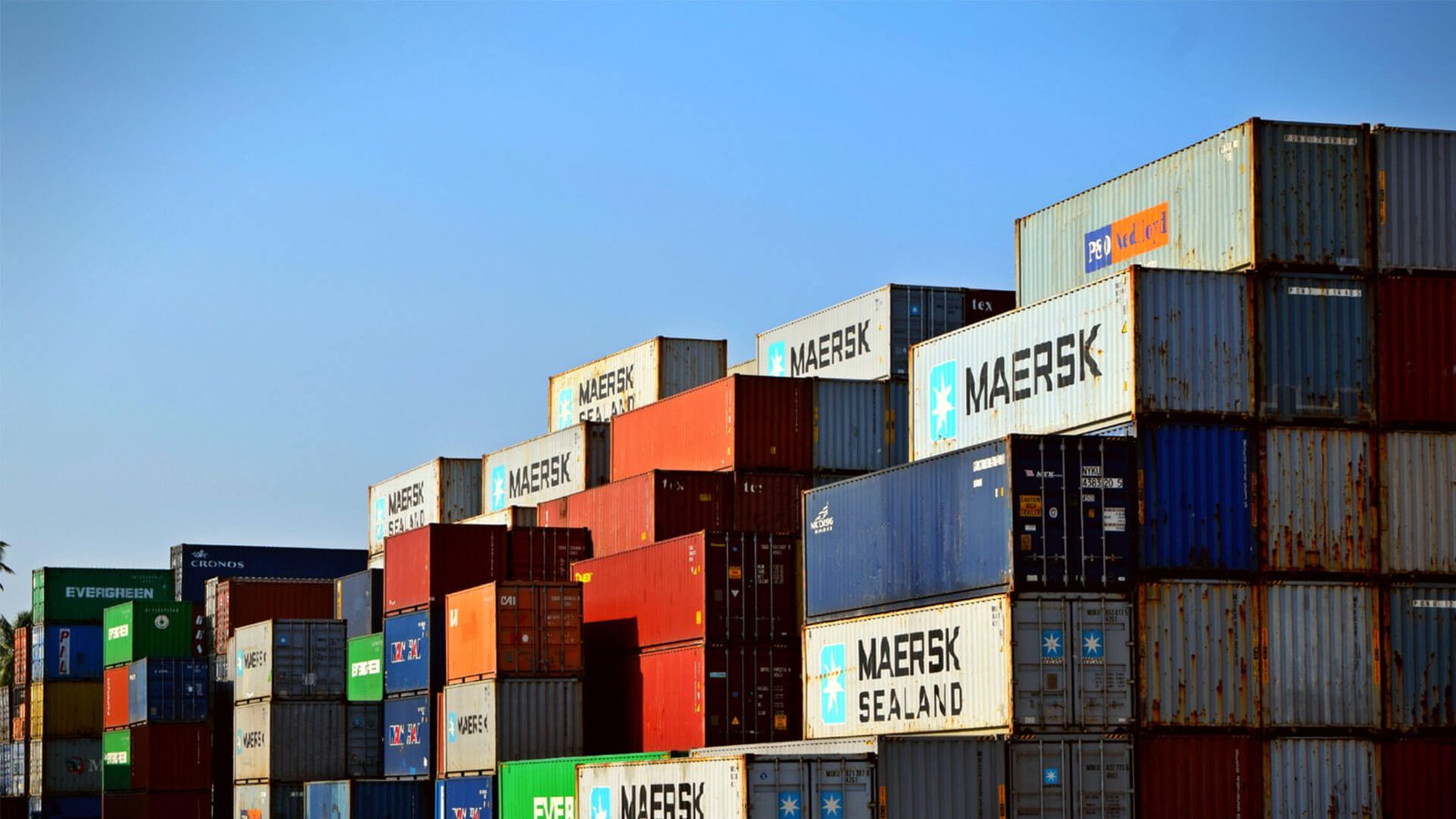 A close-up of a polished diamond being inspected with tweezers.