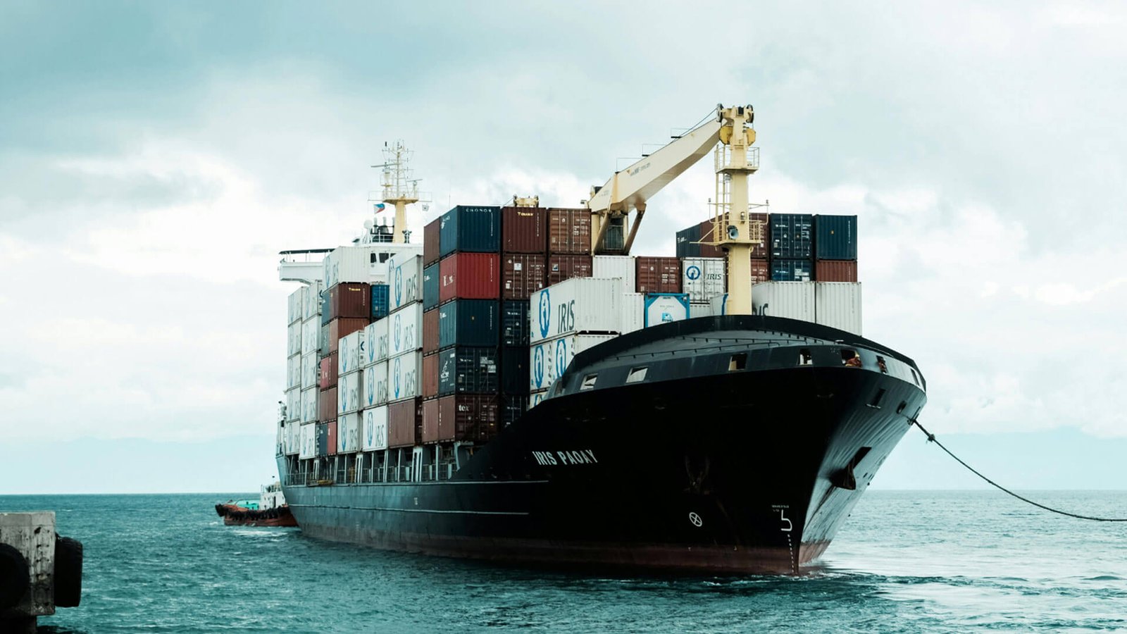 An aerial view of a port with ships and containers, highlighting the need for manifests