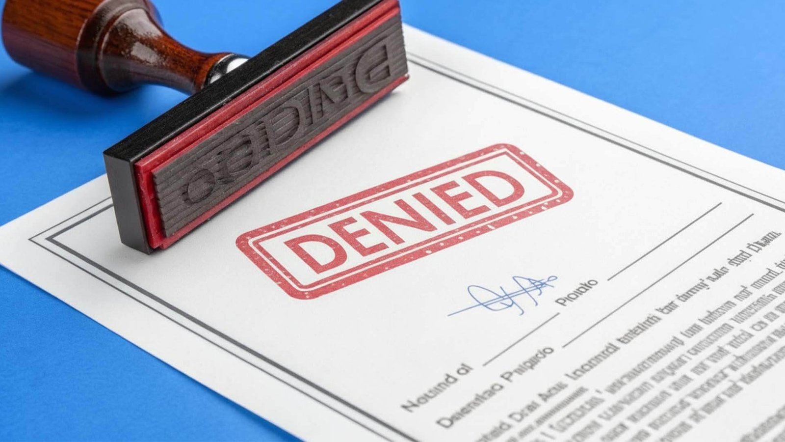 A document with a red "Denied" stamp on it