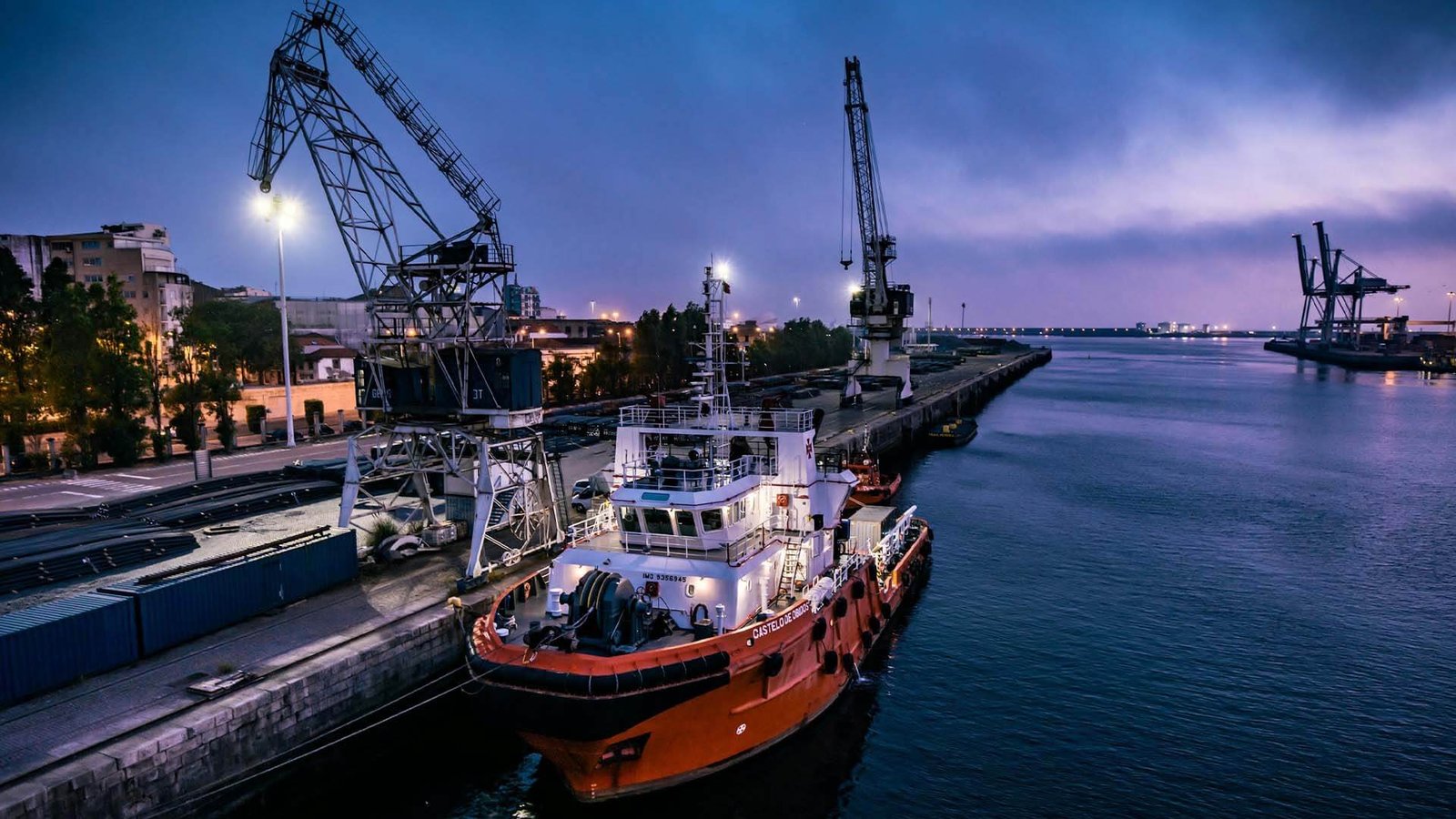 An aerial view of a shipping port with containers, representing global trade and logistics choices like FTZ or bonded warehouses